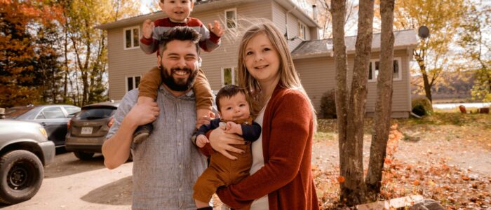 family of 4 in front house